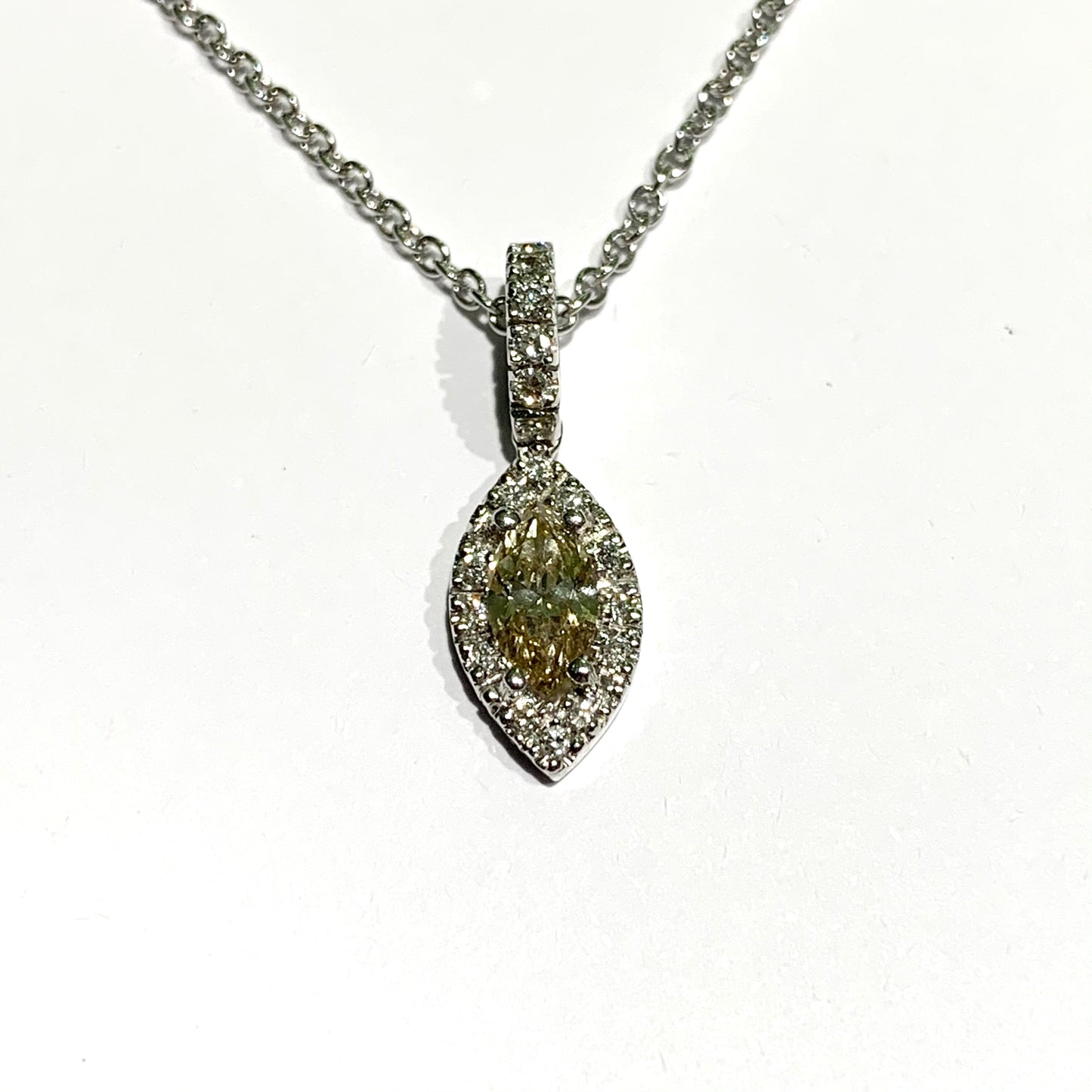 Collana in oro bianco 18kt con diamante ovale circondato da piccoli diamanti. Lunghezza catena 42 cm. Caratura diamanti 0,68. Dimensione ciondolo 2x0,8 cm + 0,7 cm l'anellino ricoperto da diamanti. Spedizione gratuita con confezione regalo.