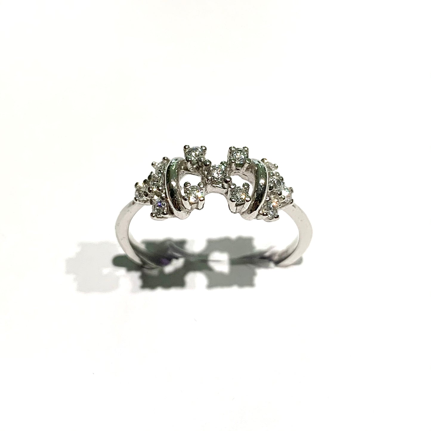 Anello in oro bianco 18kt con zirconi a forma di "X". Larghezza 0,5 cm. Misura 13.