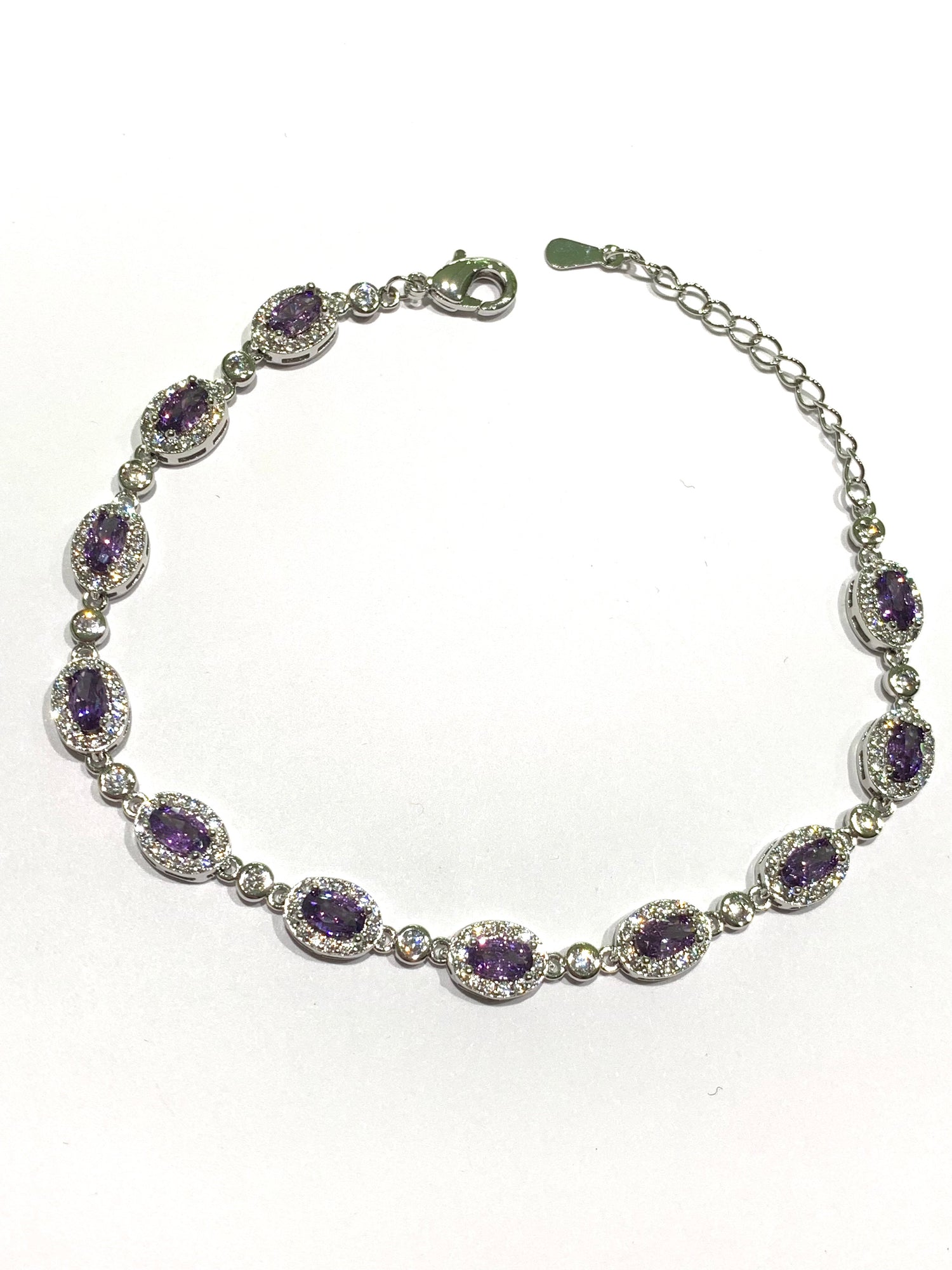 Bracciale tennis in argento con zirconi colorati circondati da zirconi bianchi. Disponibile nel colore rosso rubino oppure lilla ametista.
Lunghezza regolabile da 16 a 19 cm. 

Dimensione zirconi 0,5 cm.