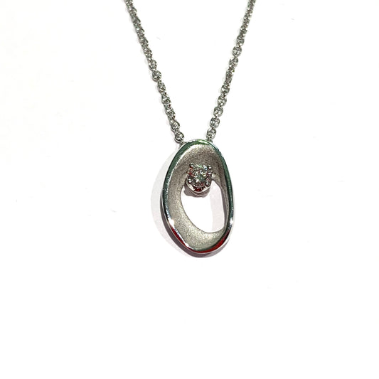 Collana in oro bianco 18kt con ciondolo ovale e diamante interno. Marchio Annamaria Cammilli con diamante di 0,10 carati. Lunghezza catena 40 cm. Dimensione ciondolo 1,4x0,8 cm. Spedizione gratuita con confezione regalo.