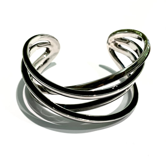 Bracciale rigido in argento quattro bracciali intrecciati con bordi smaltati neri. Circonferenza interna 21 cm, di cui 3 cm nella parte aperta. Spessore singolo bracciale 0,5 cm. Larghezza toale dei quattro bracciali 3 cm. Spedizione gratuita con confezione regalo.