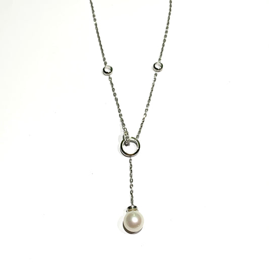 Collana in oro bianco 18kt con cerchietti con diamanti e perla coltivata pendente. Lunghezza catena 44 cm. Lunghezza ciondolo pendente 5,5 cm. Dimensioni perla 1 cm. Spedizione gratuita con confezione regalo.